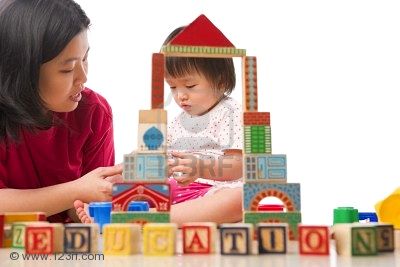 7283216-chinese-mother-and-child-playing-together-with-word-education-in-front-of-them